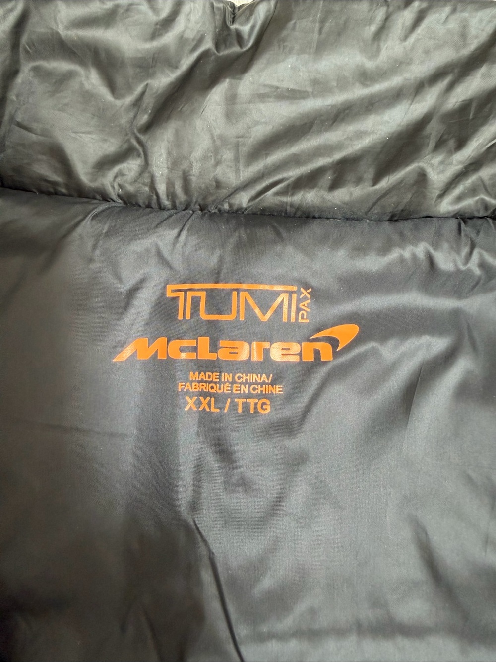 TumiPAX McLaren Packable Black Puffer Vest/Pillow with Orange Trim - Picture 4 of 12